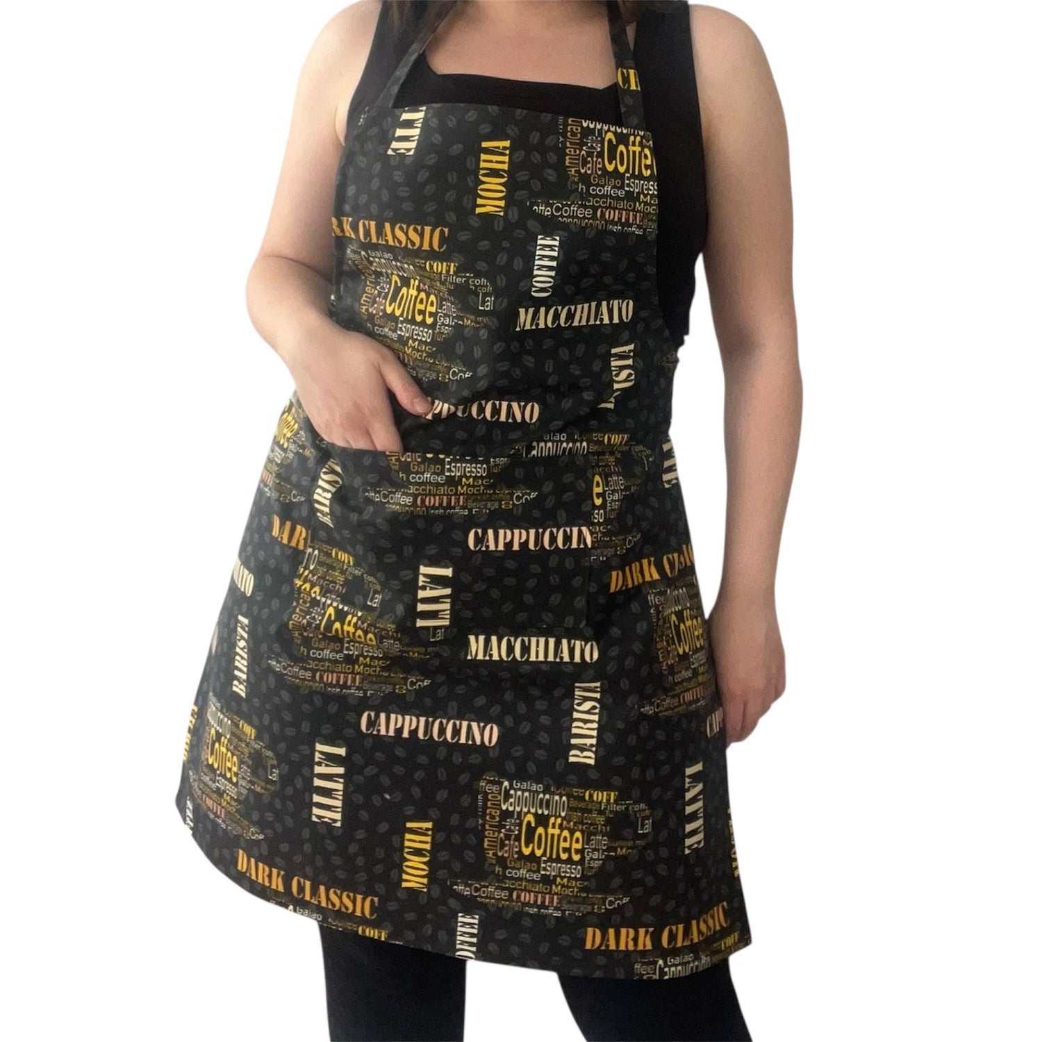 Handmade coffee-themed kitchen apron with yellow and white coffee name prints on black fabric, modeled for kitchen textiles collection
